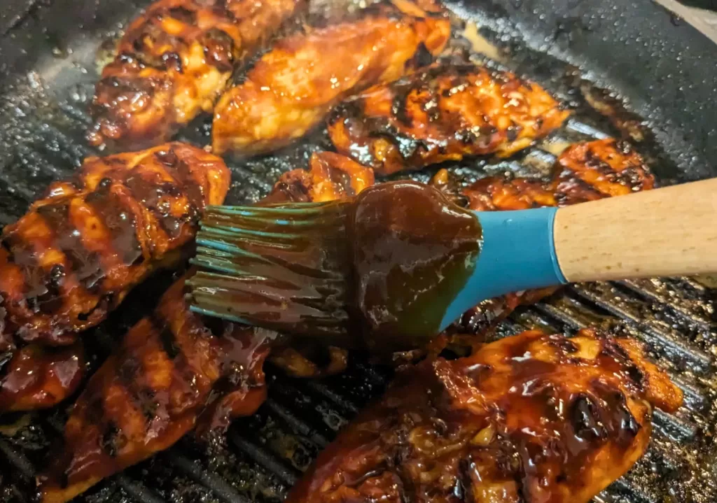 brushing sauce on chicken