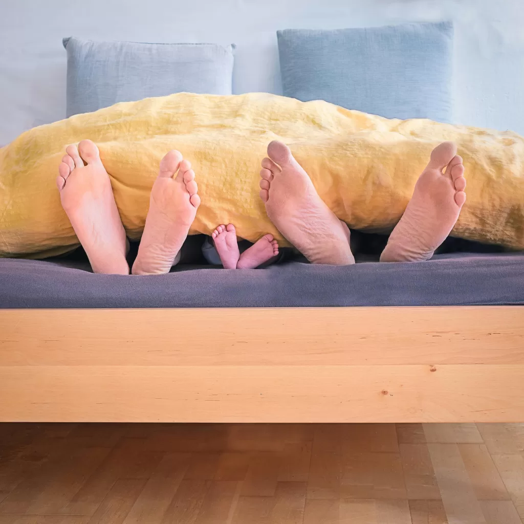 feet hanging out of bed