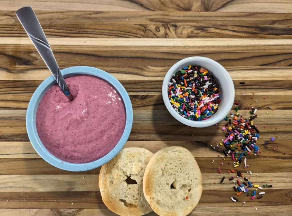 Breakfast, beet spread, vibrant, nutritious, healthy recipe, bagels, homemade, morning routine, colorful, nutrient-rich, dip, toast, breakfast bowl, beet recipe, food photography, wholesome, fresh ingredients, beetroot spread, health food, homemade spread, playful, sprinkles, breakfast delight